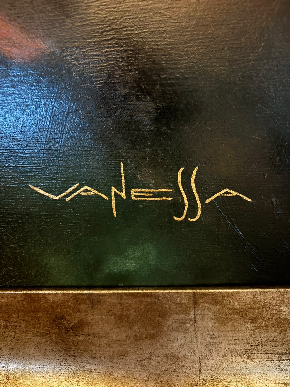 Firma dorada de Vanessa sobre el lienzo